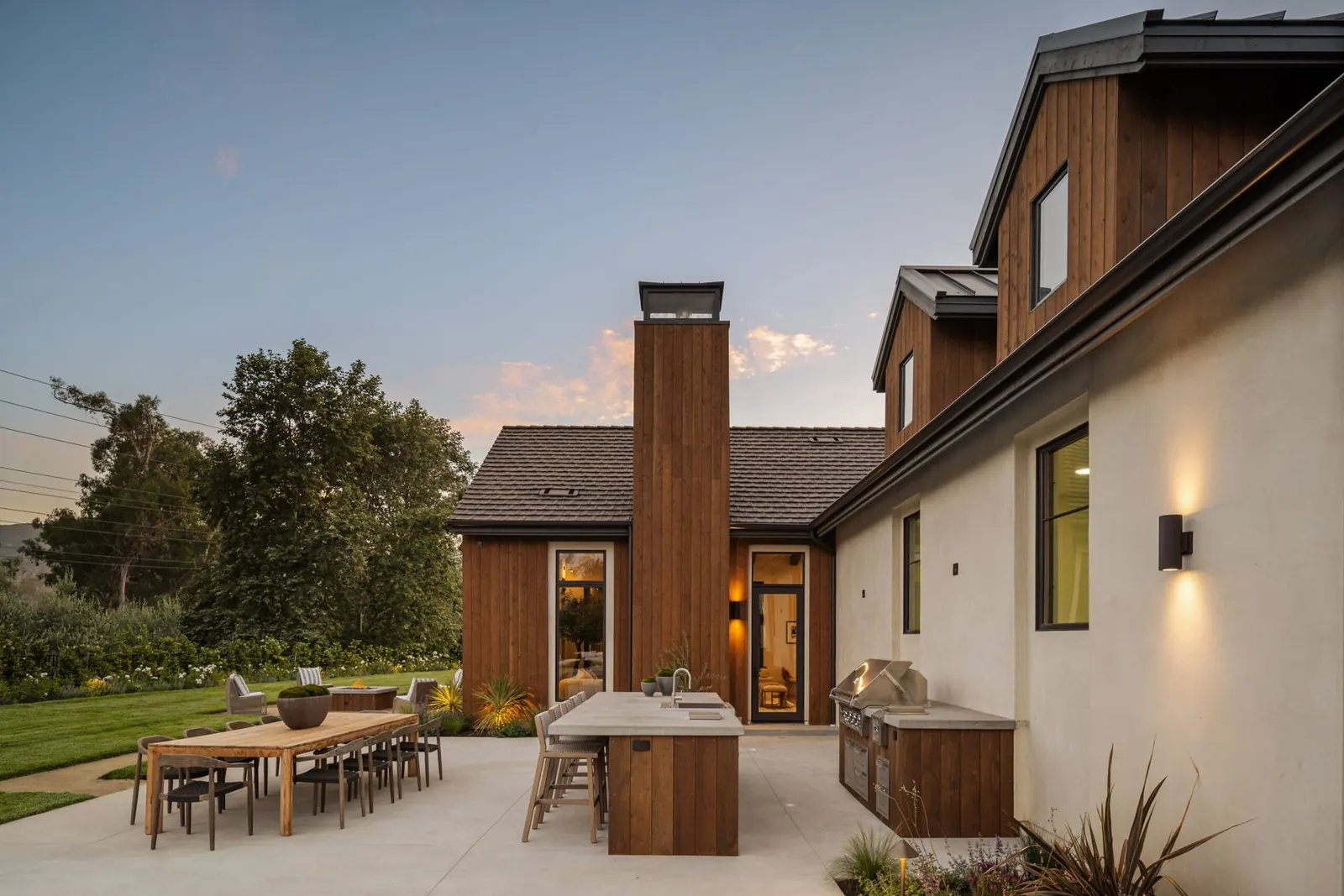 Outdoor kitchen and al fresco dining at dusk